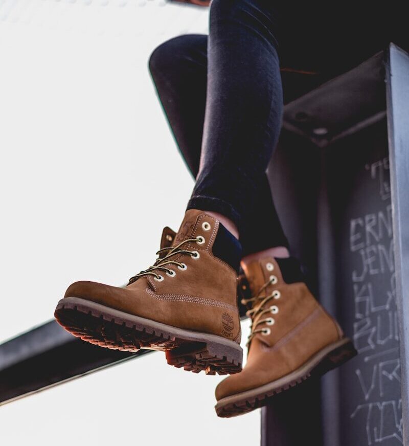 sitting woman wearing black pants and brown work boots